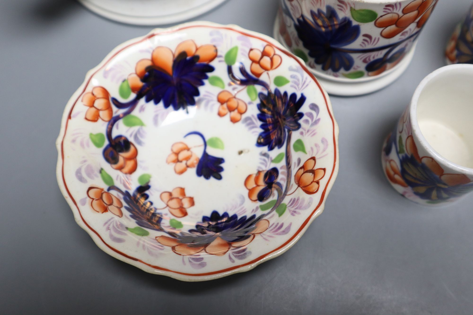 Eight pieces of Ironstone china including two jugs and a three handled cider mug